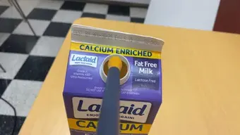 The sensor probe touching milk (cardboard)